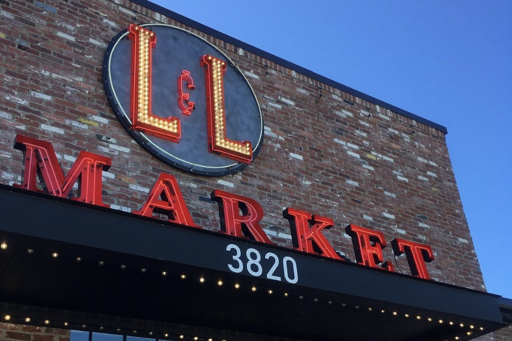 The L and L Market storefront on Charlotte Avenue, with its marquee medallion sign and red MARKET letters